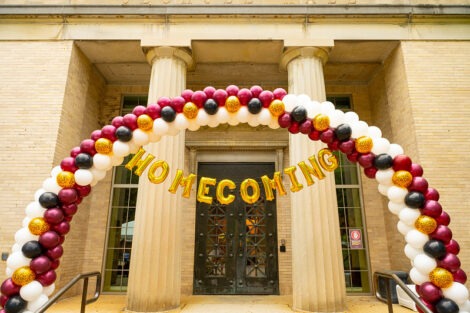 Balloon arch in front of Oechsle Hall that spells out Homecoming
